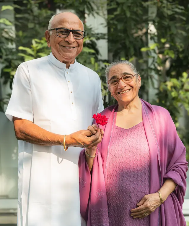 A happy retired couple smiling together outdoors