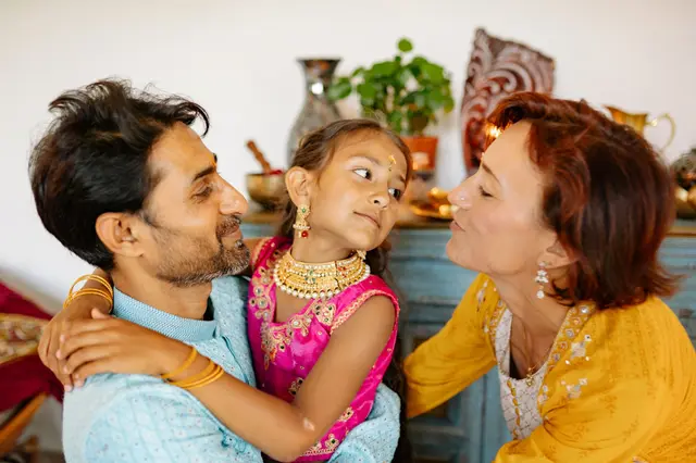 A smiling family hugging at home